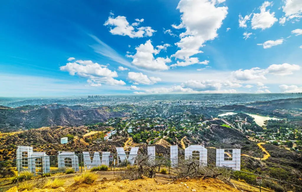 A view of hollywood sign from the top of a hill.