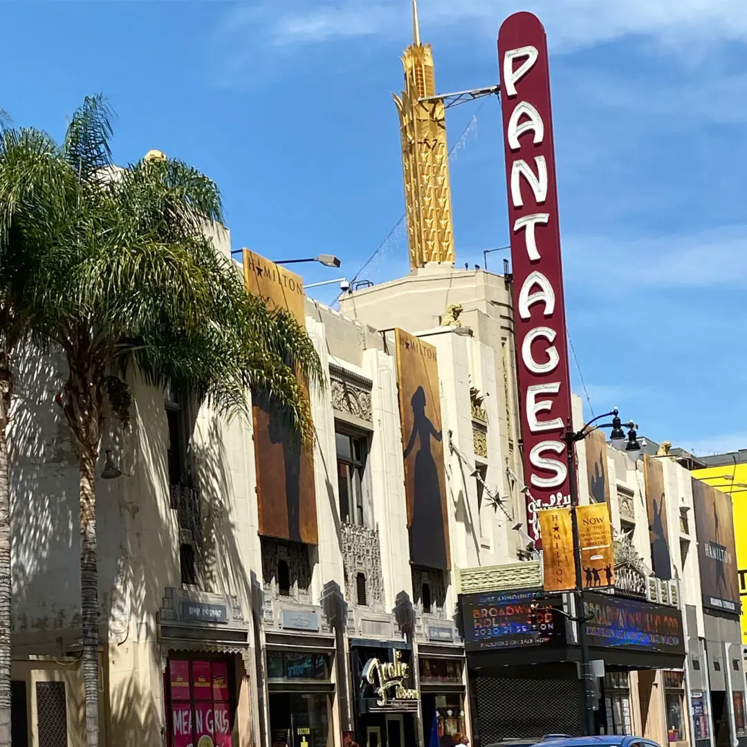 A theater sign on the side of a building.