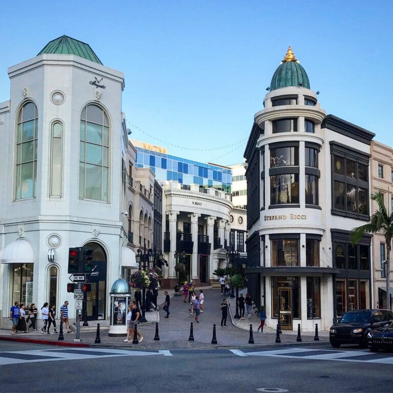 A street with many buildings and cars on the side.