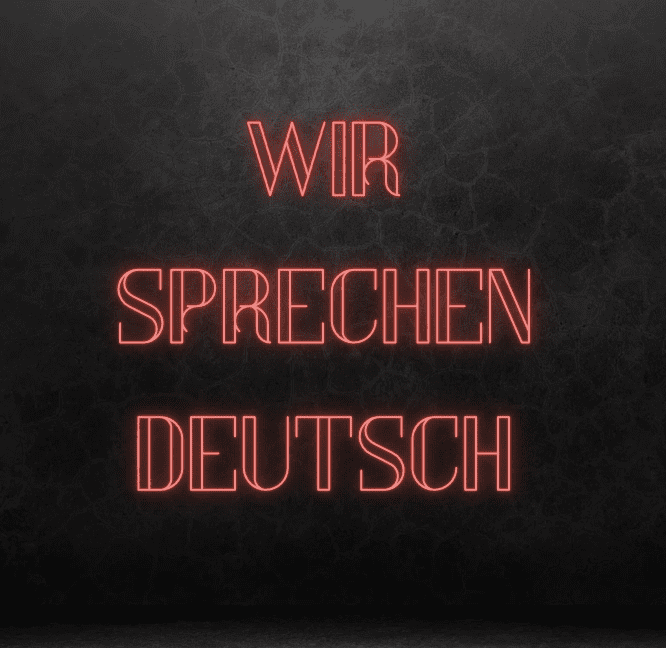 Neon sign: We speak German.