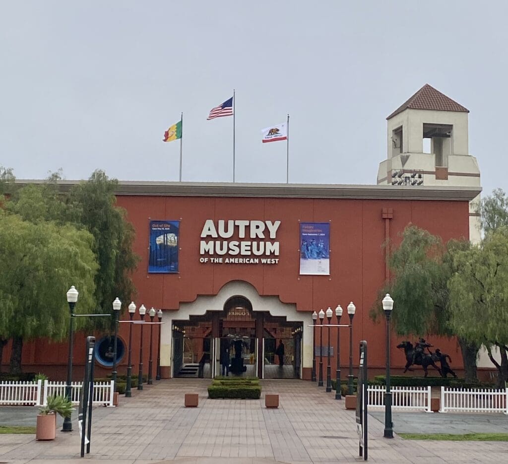 Autry Museum entrance with flags and tower