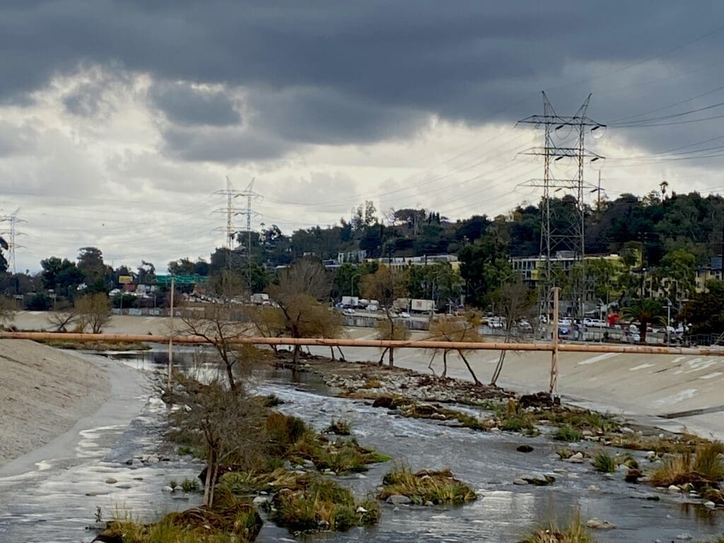 Concrete lined river channel with power lines