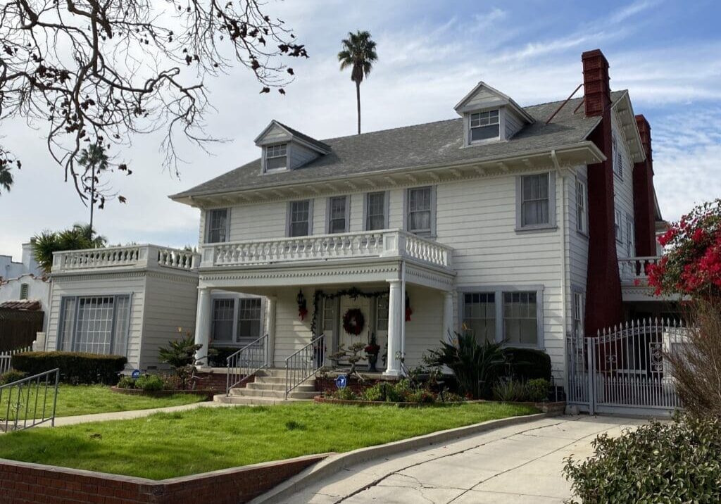 Two-story white colonial house with porch