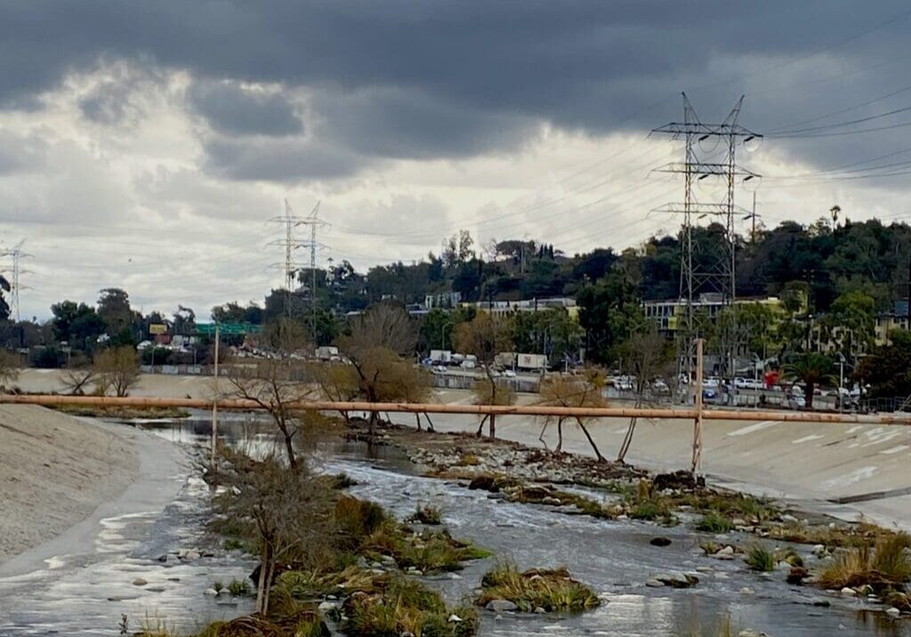Concrete lined river channel with power lines